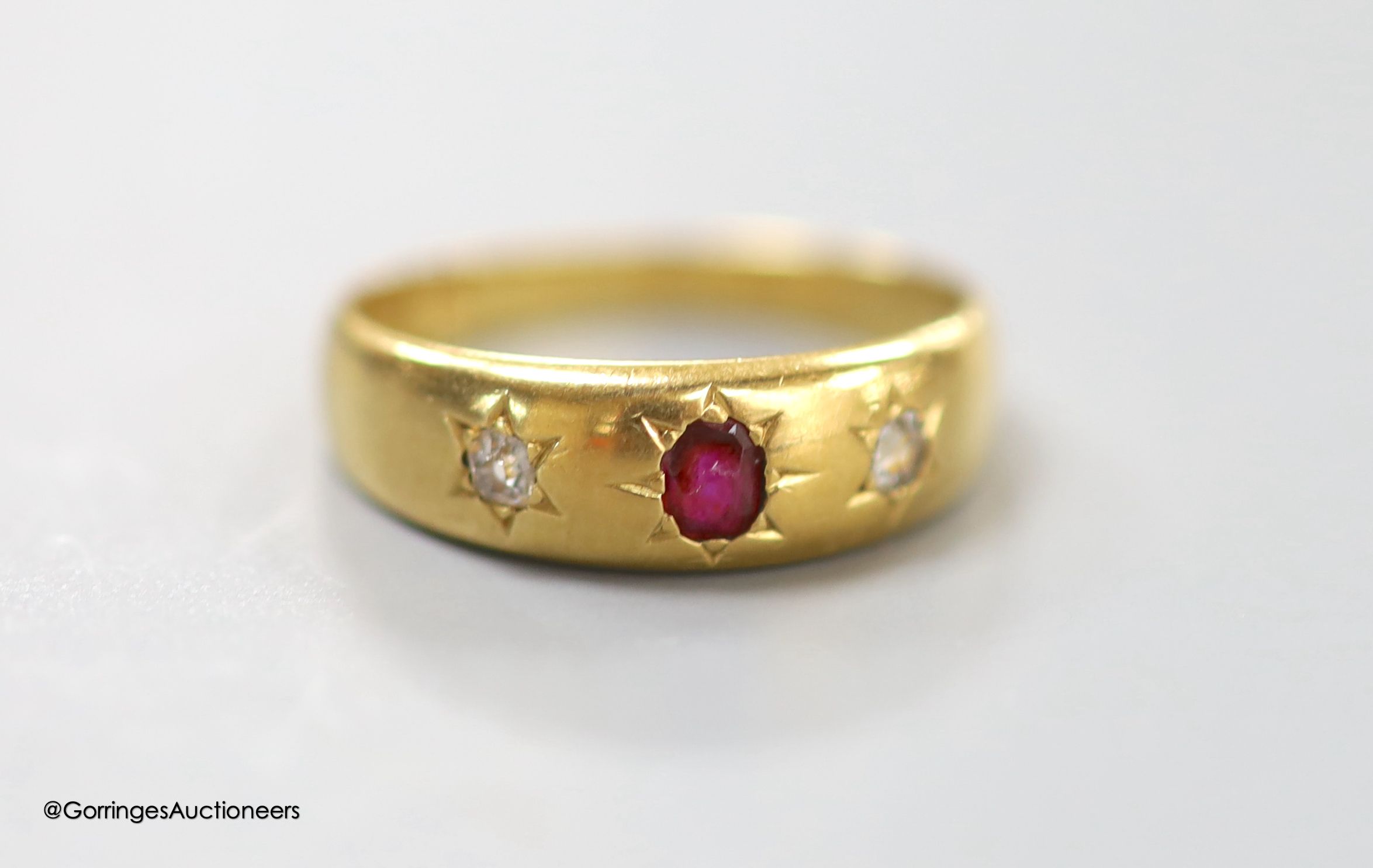 A Victorian 18ct gold and gypsy set, ruby and diamond three stone ring, size M, gross 3.5 grams.